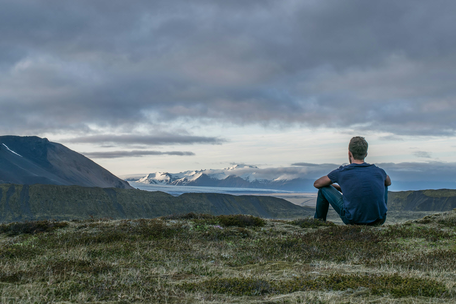 Man sitting on grass thinking